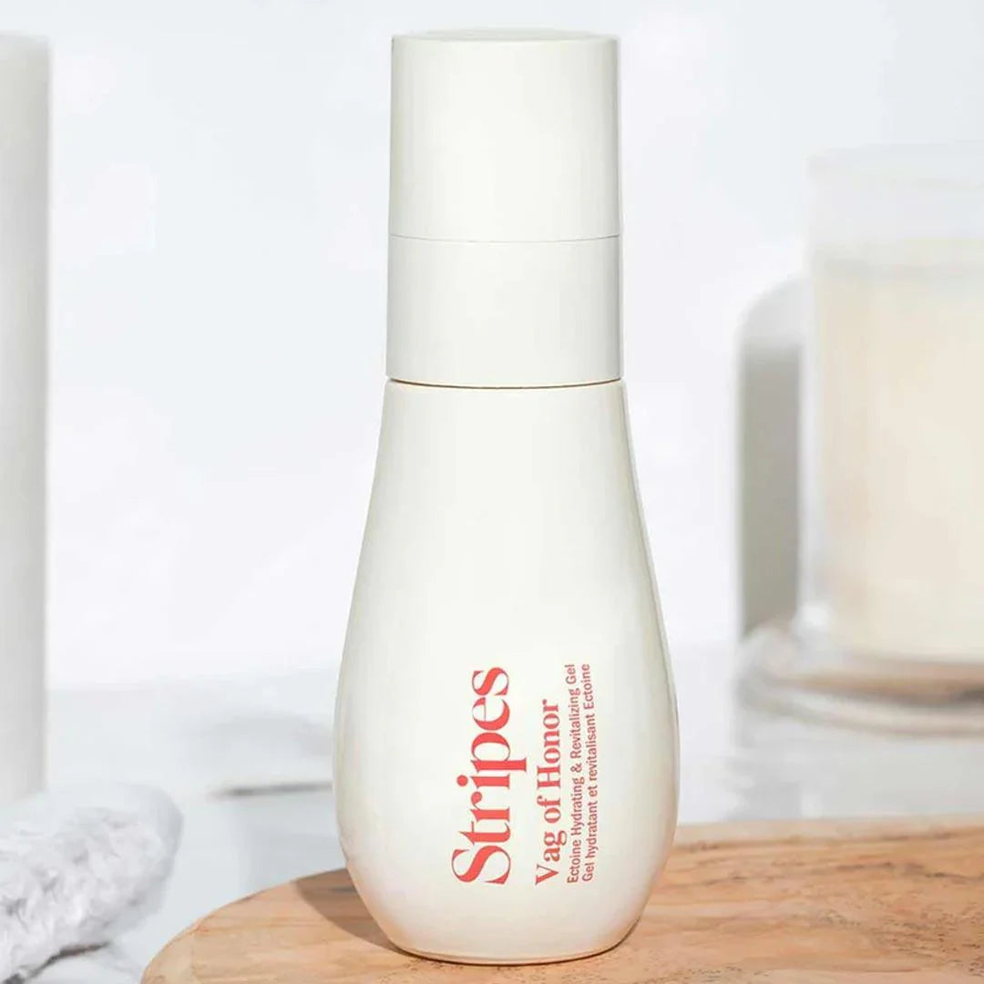 Menopause Survival Kit featuring Stripes Vag of Honor intimate gel in a sleek white bottle on wooden surface