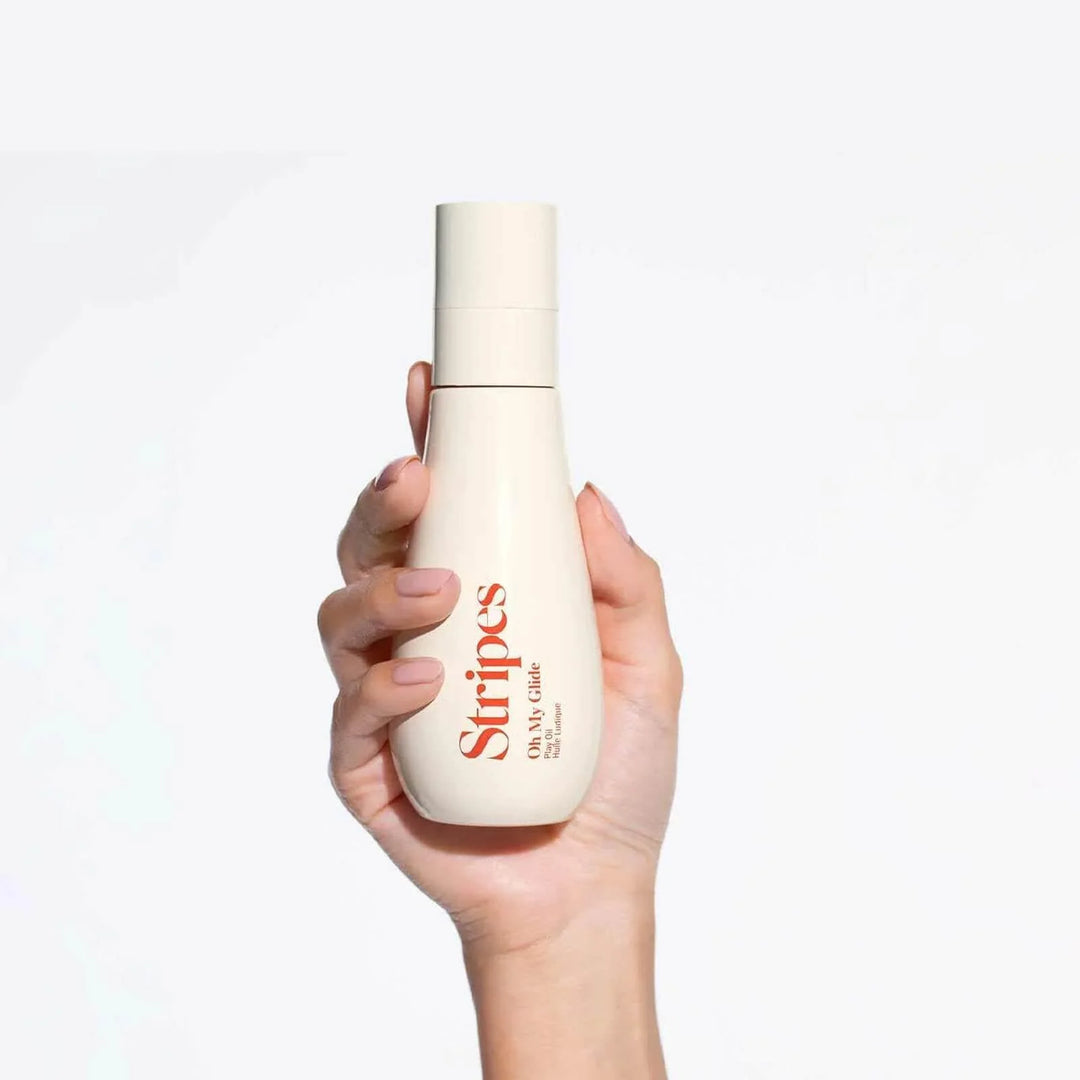 Hand holding Stripes 50mg Gel bottle, part of the Menopause Survival Kit for symptom relief.