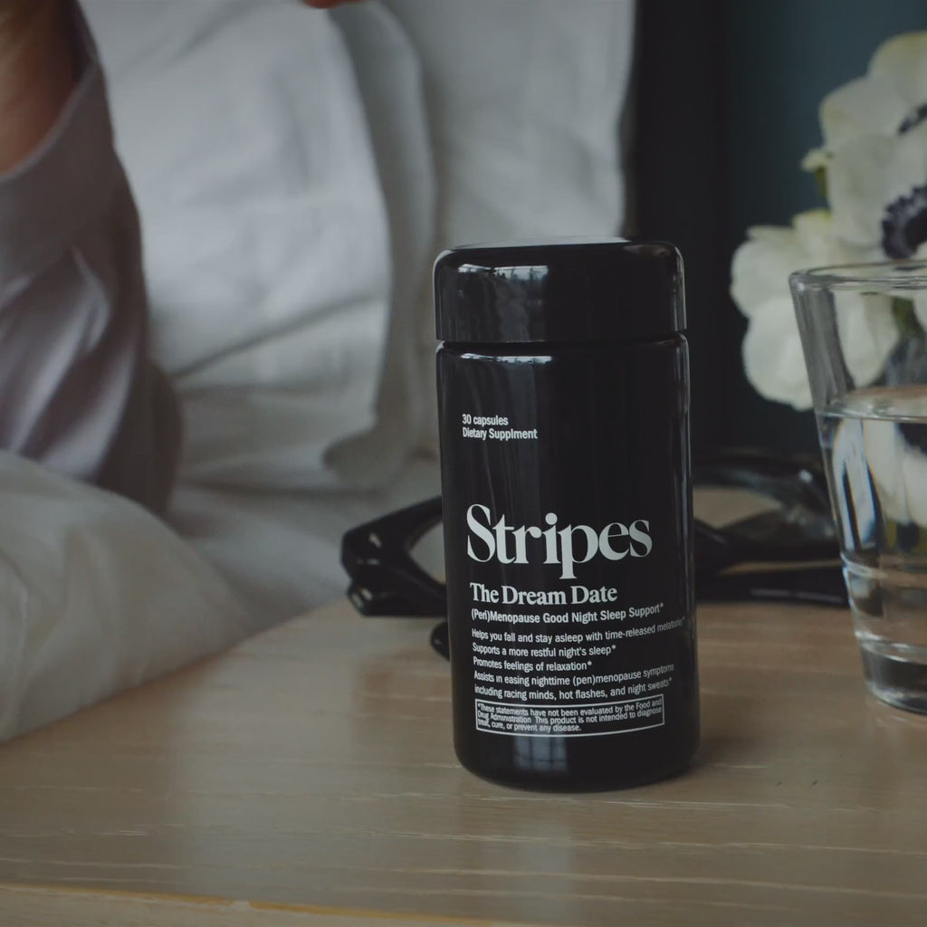Naomi Watt opening a bottle of The Dream Date Perimenopause God night Sleep support in a hotel room before going to sleep.