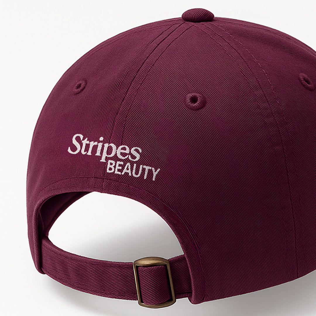 Maroon cap with 'Stripes Beauty' logo on a white background