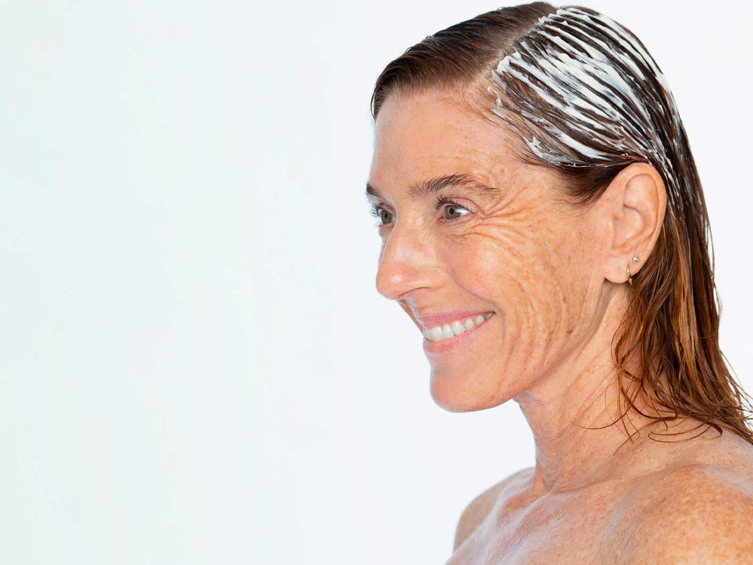 Perimenopause Survival Kit: woman applying hair treatment, addressing hair density loss in perimenopause symptoms relief.